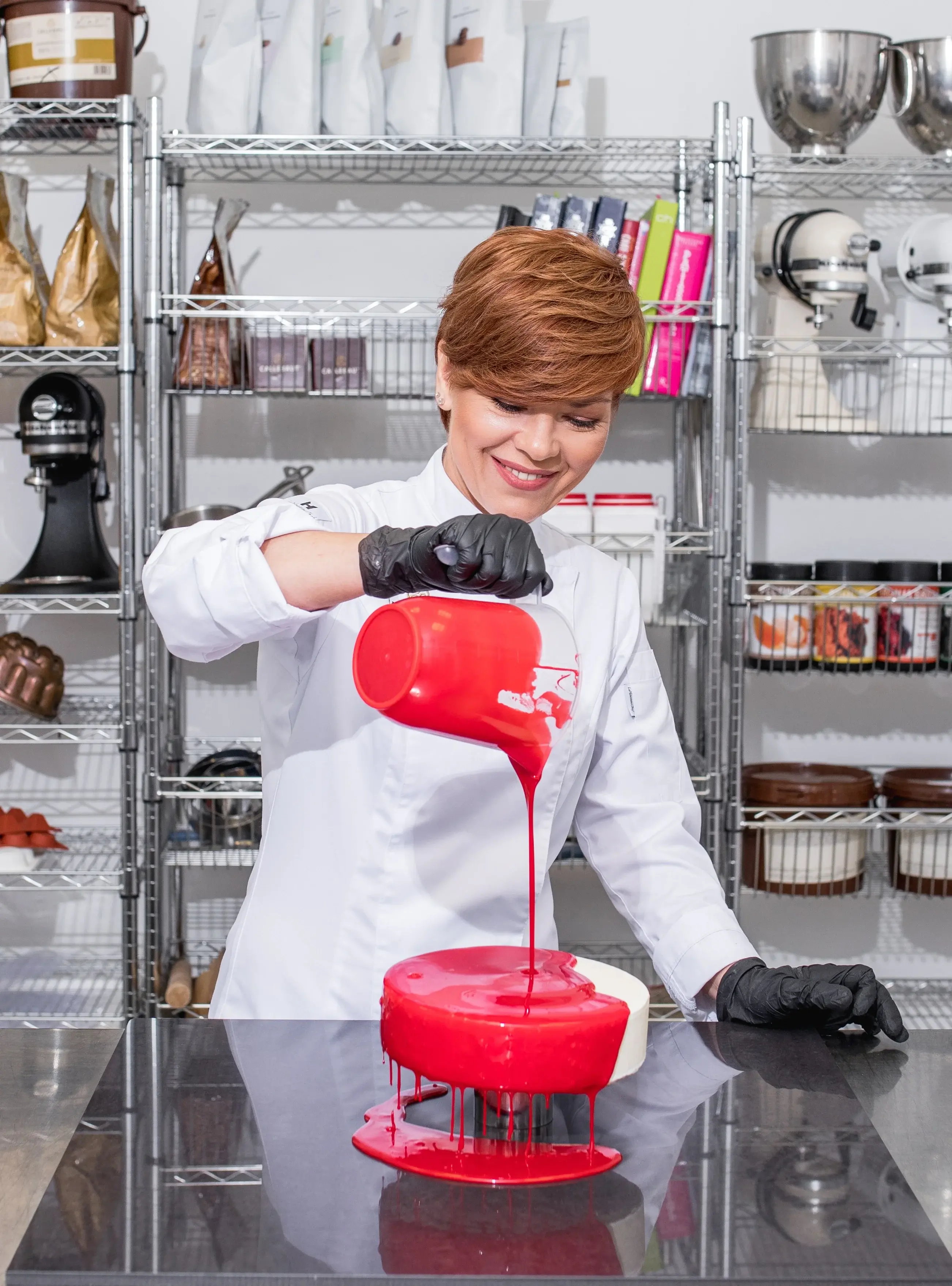 Chef Tanya Novak glazing a cake