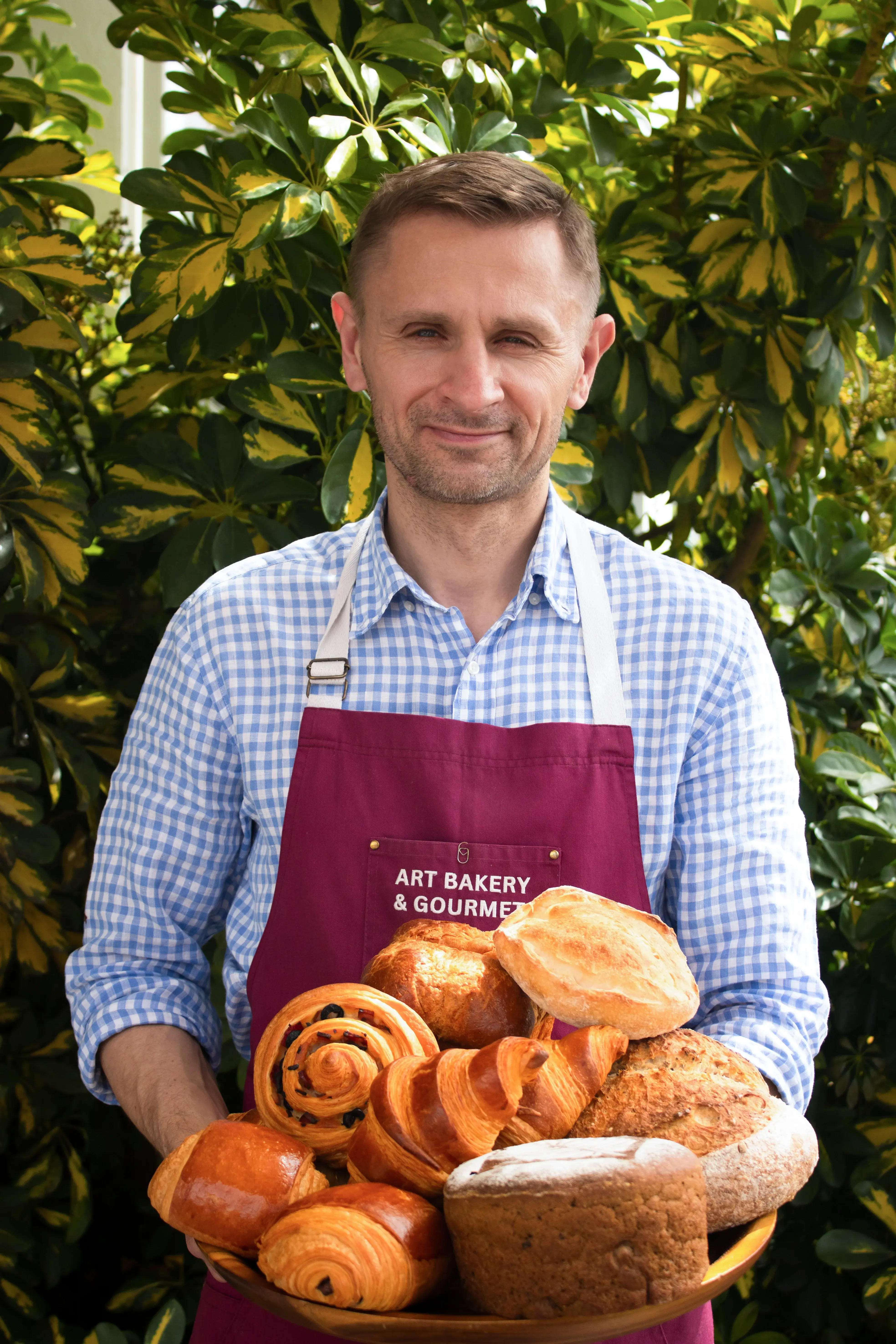 Our baker with a fresh tray of sourdough and pastries